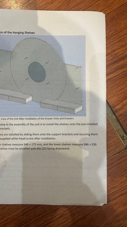 Page from the manufacturer's installation manual for the hanging shelf unit, followed during the fit-out