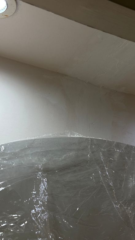 Corner of the ceiling and wall covered in protective film during installation