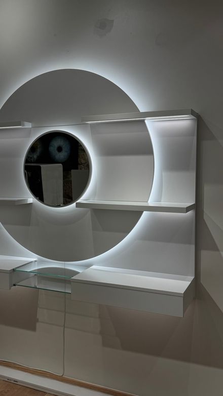 Circular backlit wall display fully mounted, shelves still empty