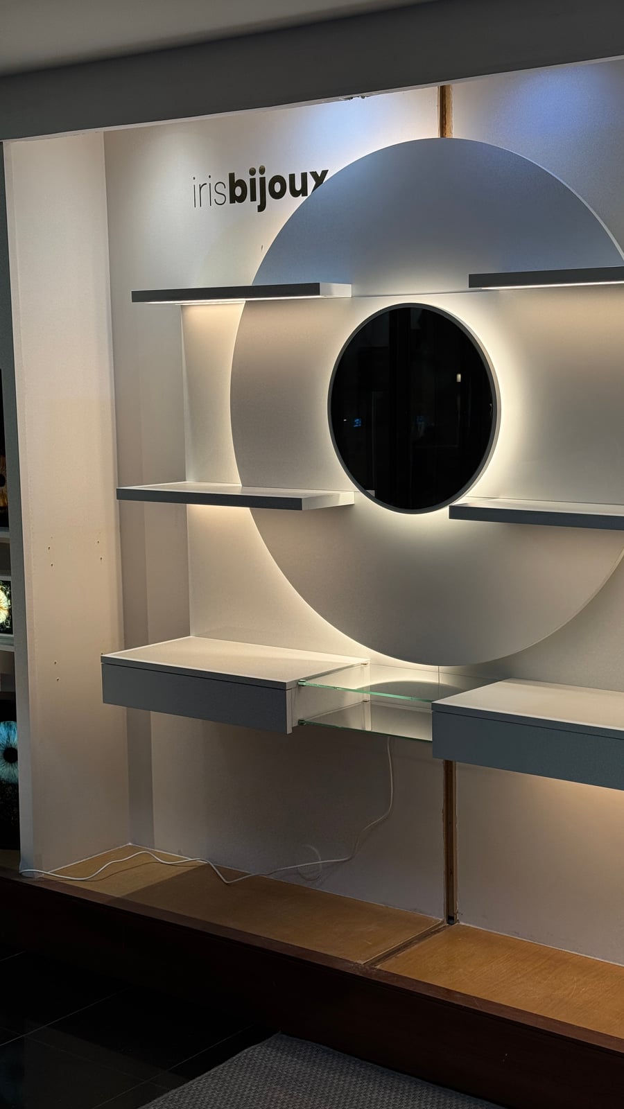 Iris Bijoux circular backlit wall display, a closer view during installation
