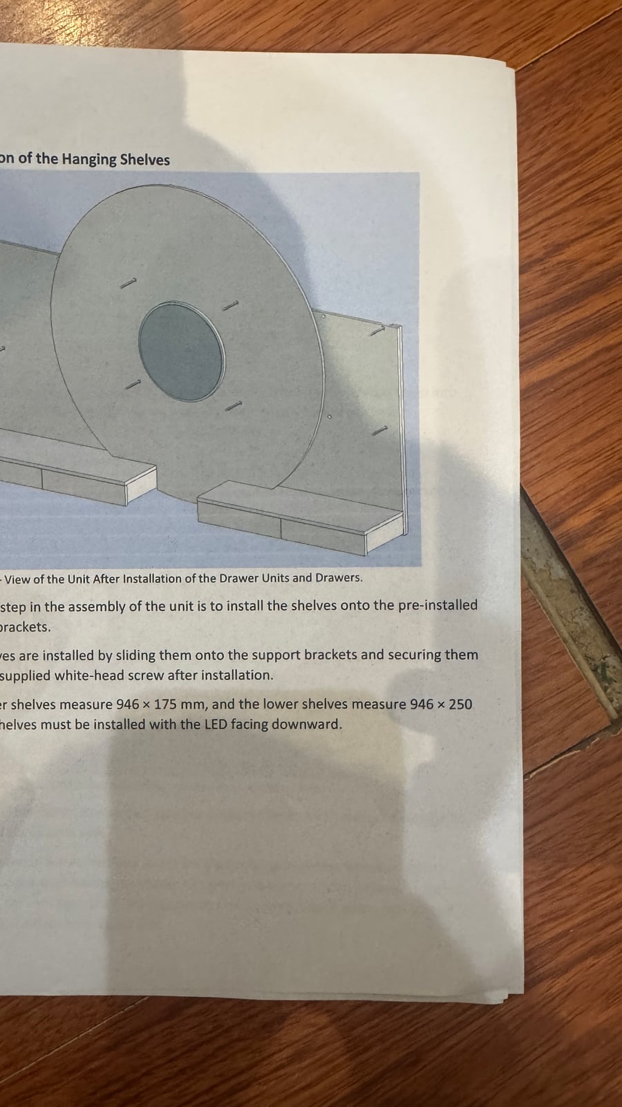 Page from the manufacturer's installation manual for the hanging shelf unit, followed during the fit-out