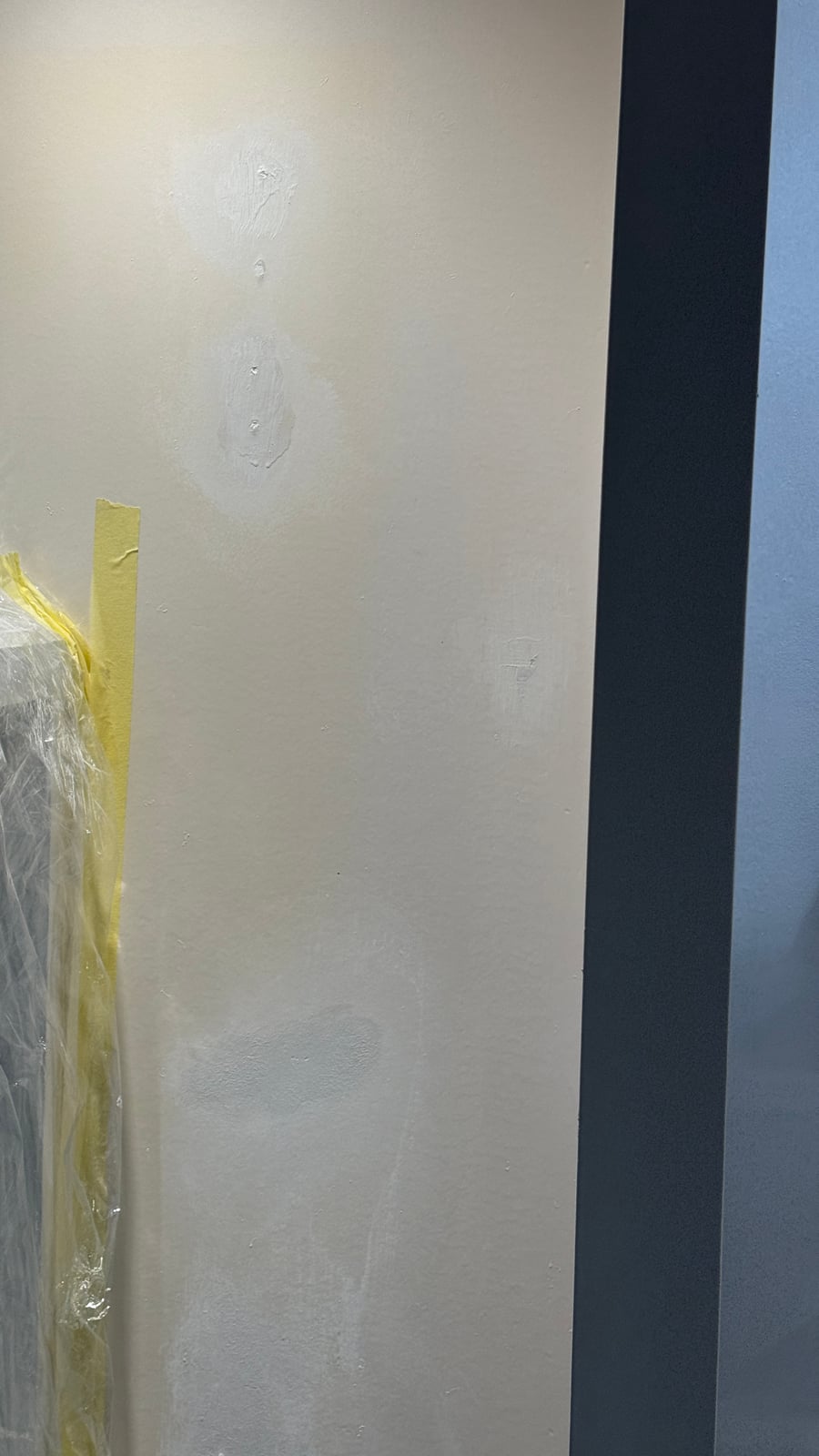 Wall corner masked with tape, prepared for a paint touch-up after installation