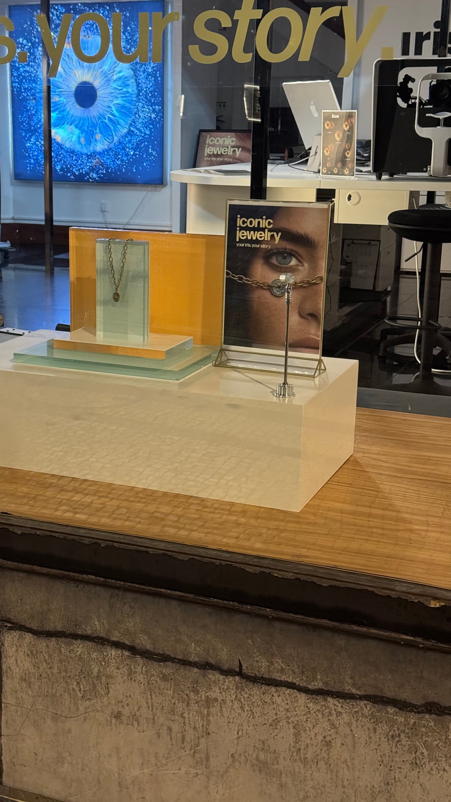 Finished LED display podium at the shop window, beneath the store's "your iris, your story" signage
